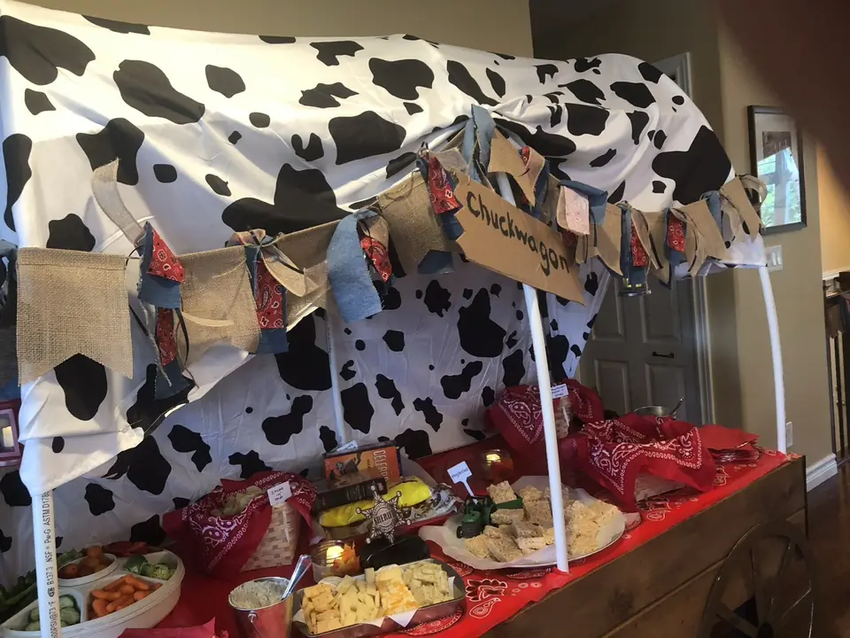 Cowboy-themed chuckwagon snack table with bandana napkins