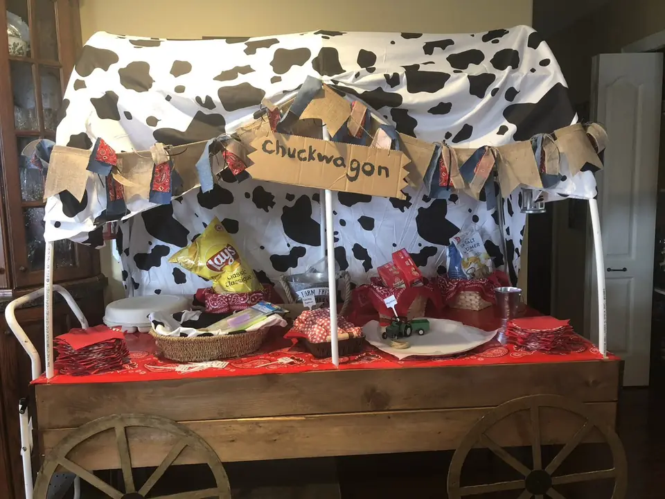 Handmade chuckwagon snack cart with cow-print canopy